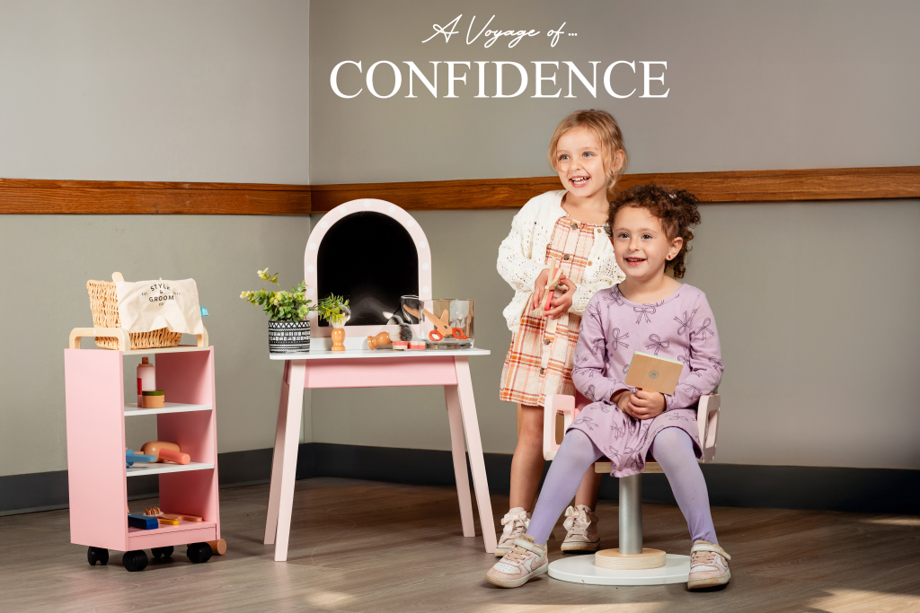 A Voyage of Confidence — two young children smiling in a classroom studio